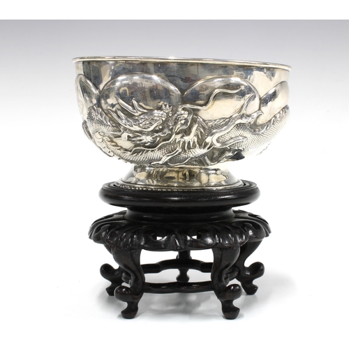 81 - WANG HING Chinese Export silver 'Dragon' bowl on a stylised hardwood stand, base signed with initial... 