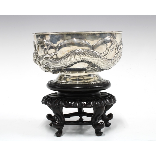 81 - WANG HING Chinese Export silver 'Dragon' bowl on a stylised hardwood stand, base signed with initial... 