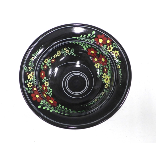 128 - American art pottery bowl, the black glazed ground with flowers in coloured enamels, 25 x 9cm.