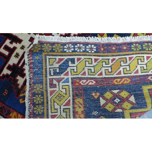 319 - Eastern wool rug, Kazak design with four star motifs, 194 x 108cm