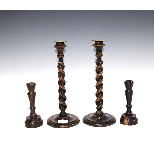 365 - A pair of oak barley twist stem candlesticks with detachable brass sconces, 31cm high, and a smaller... 