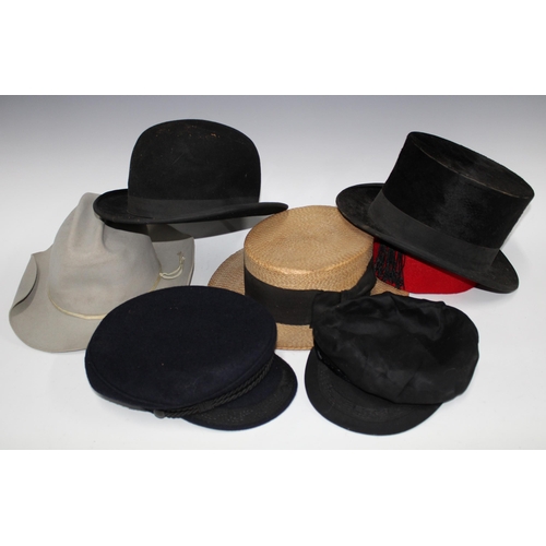 382 - Vintage hat box containing a collection of felt caps and hats to include a bowler and top hat, etc t... 