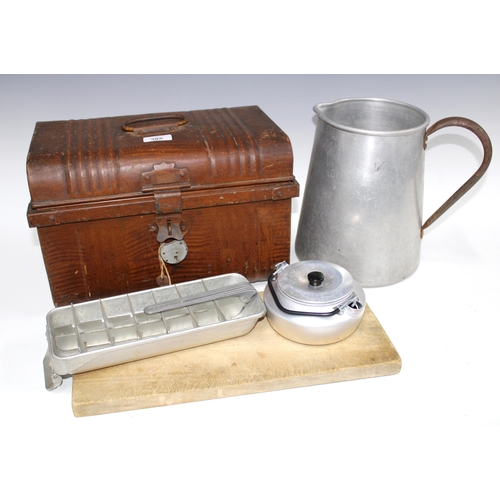 385 - Tin trunk containing a selection of vintage kitchenalia to include a chopping board, metal storage j... 