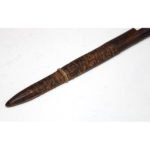 405 - Aboriginal wooden fighting stick, tapering form with chip carved hand grip, 73cm