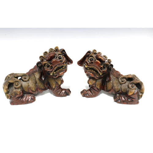 81 - A large pair of  chinoiserie wooden Temple Dogs / Lions with bead eyes (2) 27 x 21cm.