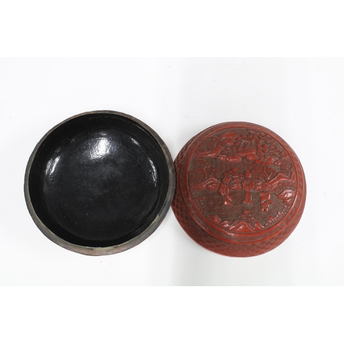 90 - Chinese red cinnabar lacquer box and cover, circular outline with a pattern of figures and landscape... 