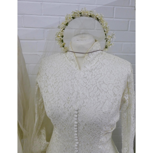 320 - Two vintage wedding dresses, together with a veiled lace cap and a floral headband veil (4)