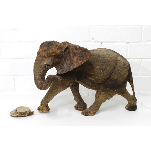 440 - Wooden elephant, naturalistically carved and modelled in a walking pose, (damage to one ear) 38cm lo... 