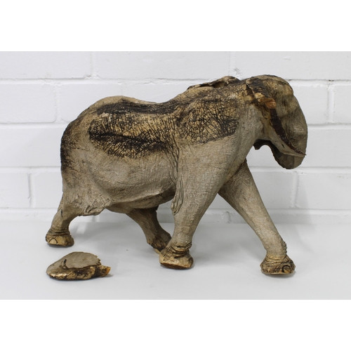 440 - Wooden elephant, naturalistically carved and modelled in a walking pose, (damage to one ear) 38cm lo... 