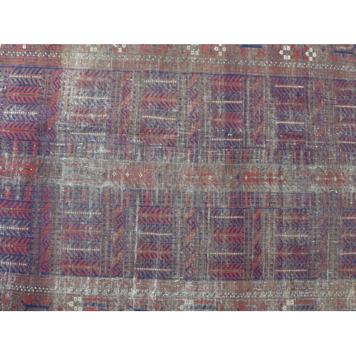 452 - Belouch rug with worn red field, 110 x 195cm.