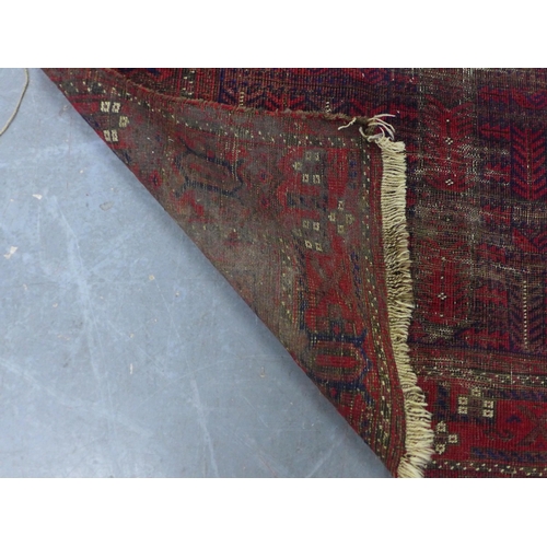 452 - Belouch rug with worn red field, 110 x 195cm.