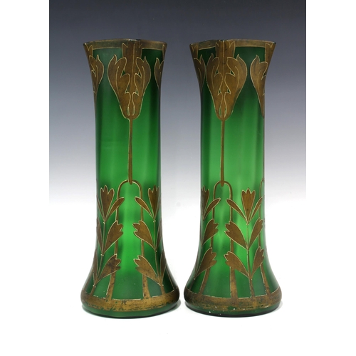 101 - A pair of French Art Nouveau green glass vases with stylised leaf pattern in gilt, of tall tapering ... 