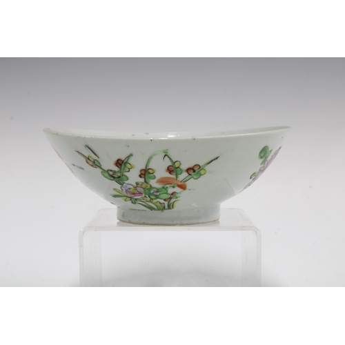 105 - Two Chinese fruit and flower pattern plates and a similarly decorated bowl,  (3) 23cm.