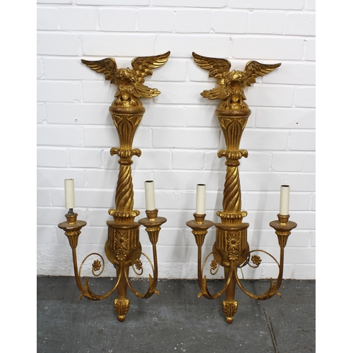 359 - A pair of giltwood wall lights with eagle surmounts and twin branches (2) 33 x 85cm.