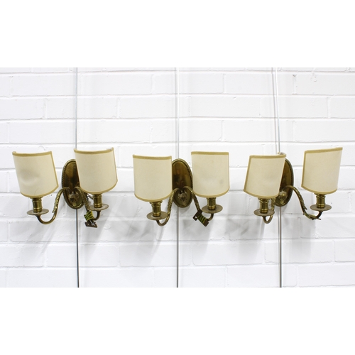 364 - A set of three brass wall lights with twin branches and shades (3) 22 x 16cm.