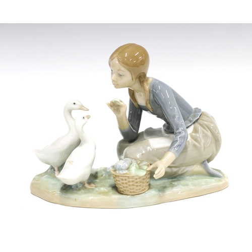 61 - Lladro figure of a girl feeding two geese, printed backstamp, 23 x 18cm.