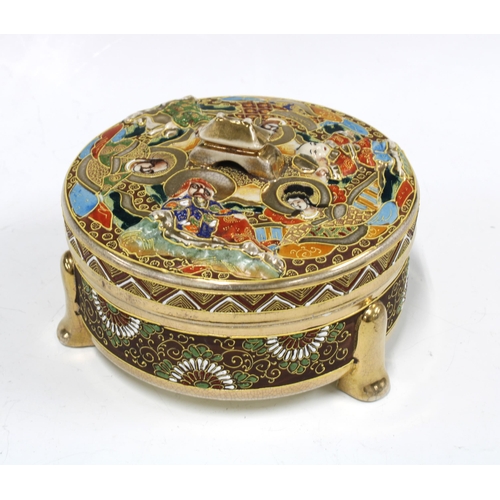 64 - Japanese Satsuma style earthenware box and cover, of circular form and decorated with figures and  c... 