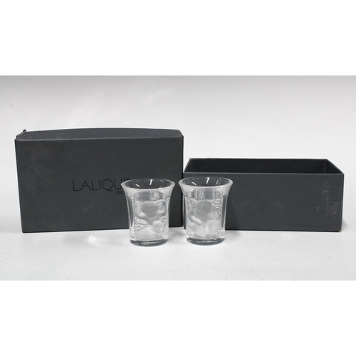 80 - A pair of Lalique  'Les Enfants' clear and frosted liqueur or shot glasses, signed and boxed (2) 4 x... 