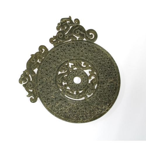 384 - Jade Bi Disc, textured and with pierced surmounts, 8.5cm diameter