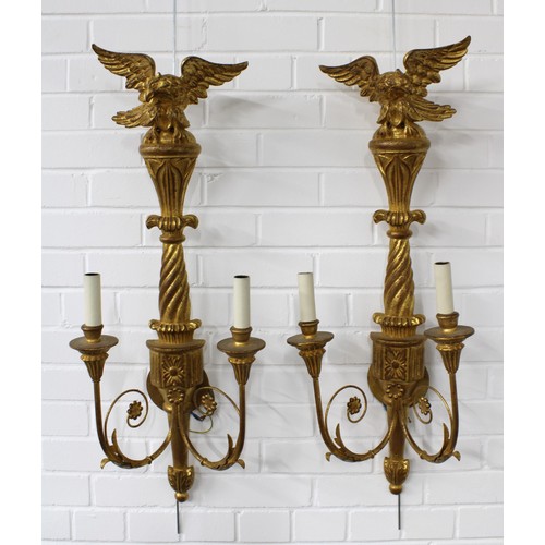 359 - A pair of giltwood wall lights with eagle surmounts and twin branches (2) 33 x 85cm.