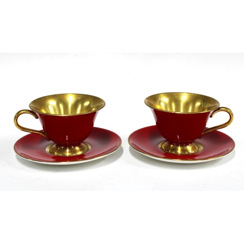 101 - The Royal Collection, a pair of red glazed porcelain cups and saucers (4)