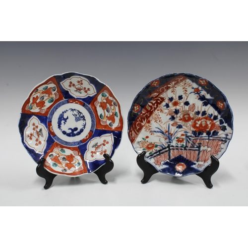 106 - A group of Imari bowls and plates, each typically decorated with chrysanthemums and foliage and with... 