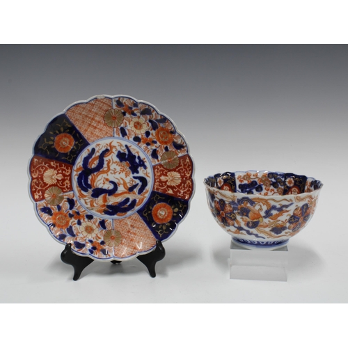 106 - A group of Imari bowls and plates, each typically decorated with chrysanthemums and foliage and with... 