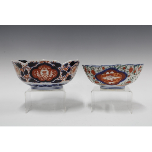 106 - A group of Imari bowls and plates, each typically decorated with chrysanthemums and foliage and with... 