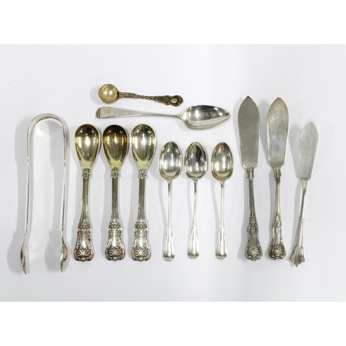 31 - A collection of silver spoons a set of Georgian silver sugar tongs, silver butter knives, etc all wi... 