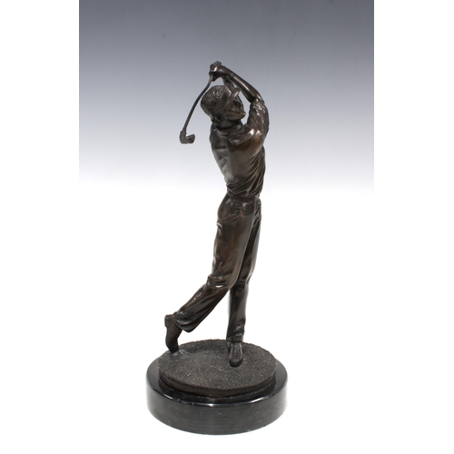 387 - Bronze patinated metal figure of a golfer in full swing,  on a marble base, 33cm