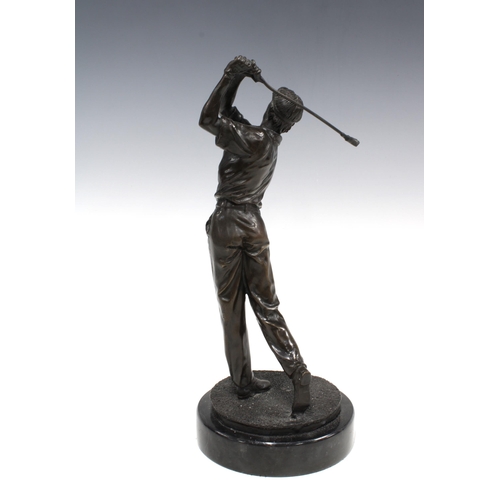 387 - Bronze patinated metal figure of a golfer in full swing,  on a marble base, 33cm