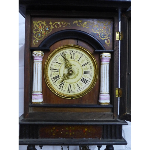 427 - Gothic style wall clock in a stained pine case, with weights and pendulum