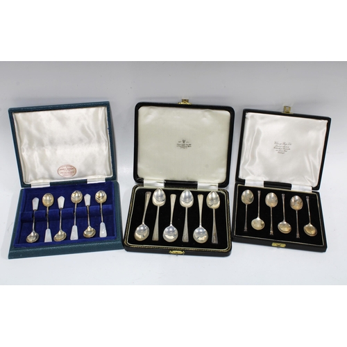 62 - Two cased sets of six silver teaspoons together with a cased set of six silver and shell teaspoons (... 