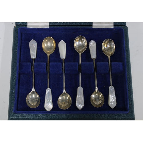 62 - Two cased sets of six silver teaspoons together with a cased set of six silver and shell teaspoons (... 