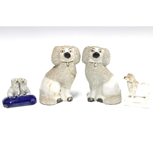 83 - A group of four 19th century Staffordshire poodles with textured clay, (4) (a/f) tallest 12cm