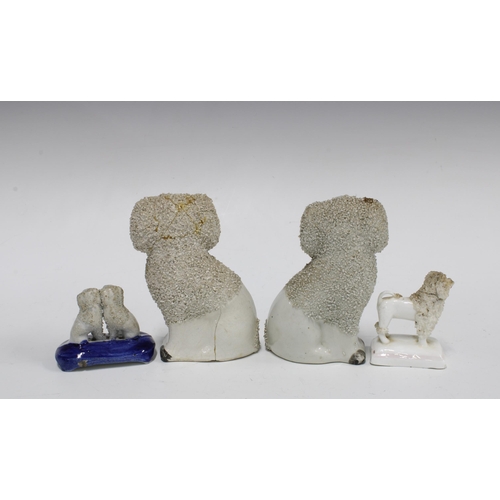 83 - A group of four 19th century Staffordshire poodles with textured clay, (4) (a/f) tallest 12cm