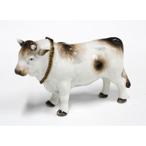 87 - Gilt metal mounted porcelain table snuff in the form a bull, with blue crossed swords mark but likel... 