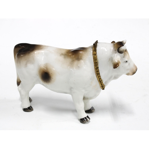 87 - Gilt metal mounted porcelain table snuff in the form a bull, with blue crossed swords mark but likel... 