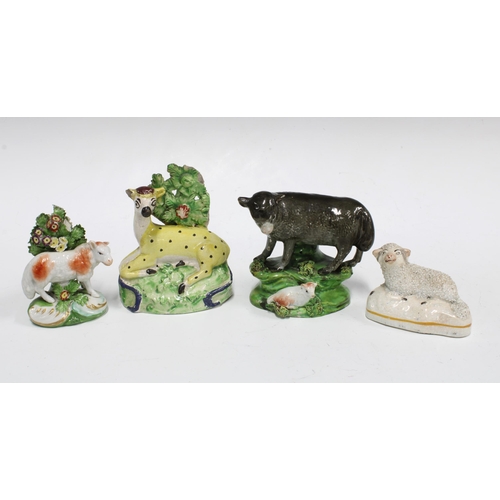 90 - A group of 19th century Staffordshire animals to include a Pearlware cow and calf, and  yellow glaze... 