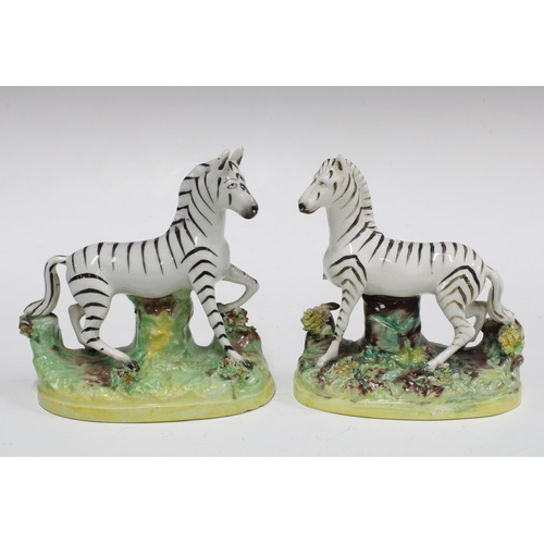 92 - A pair of Staffordshire pottery Zebra, (one a/f) (2) 12cm