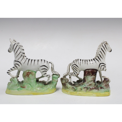 92 - A pair of Staffordshire pottery Zebra, (one a/f) (2) 12cm