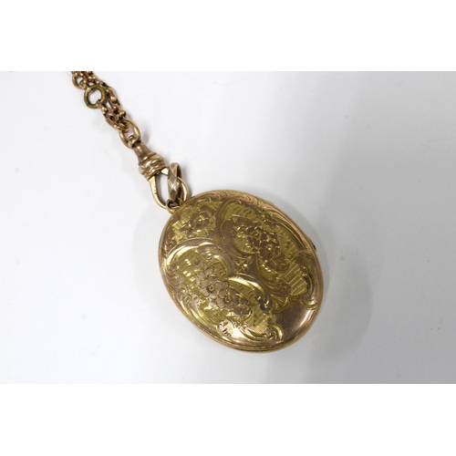 21 - A foliate engraved yellow metal locket on a guard chain, hook clasp stamped 9ct