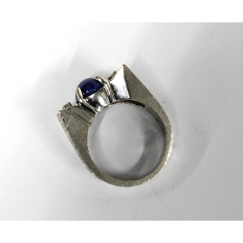 27 - 14ct white gold ring claw set with a star sapphire and four diamonds, stamped 14k, overall weight 8.... 