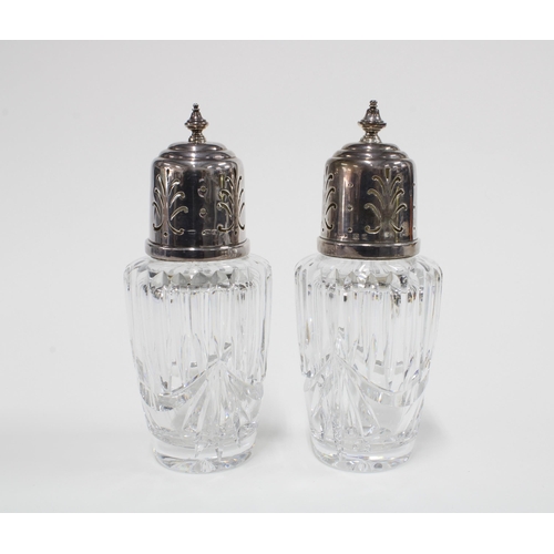 43 - A pair of George V silver topped glass  sugar casters,  Birmingham 1934,  17cm (2)