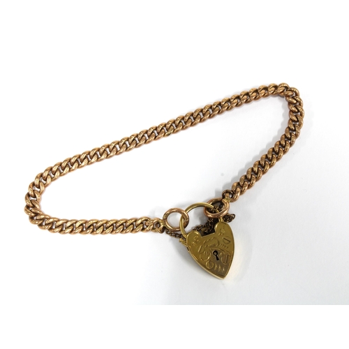 82 - 9ct gold curb link bracelet with a 9ct gold heart shaped padlock