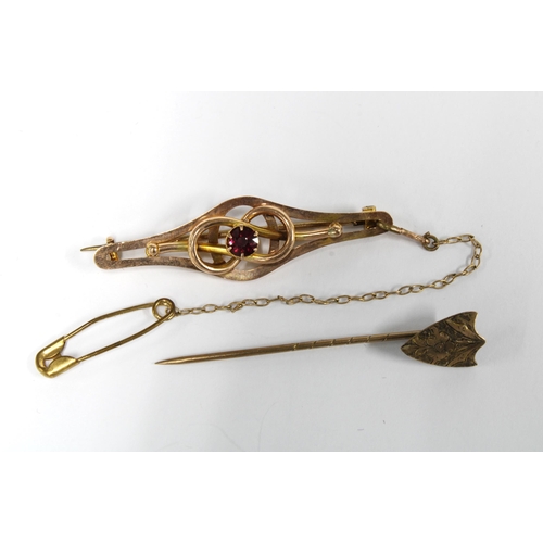 87 - 9ct gold brooch and a shield tiepin (2)