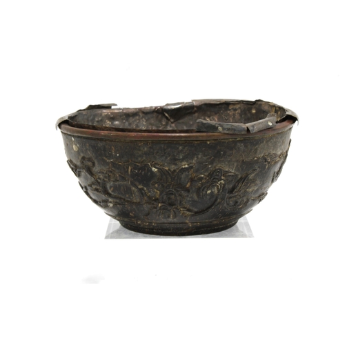 409 - 19th century carved coconut bowl with a white metal liner, (a/f) 13cm diameter