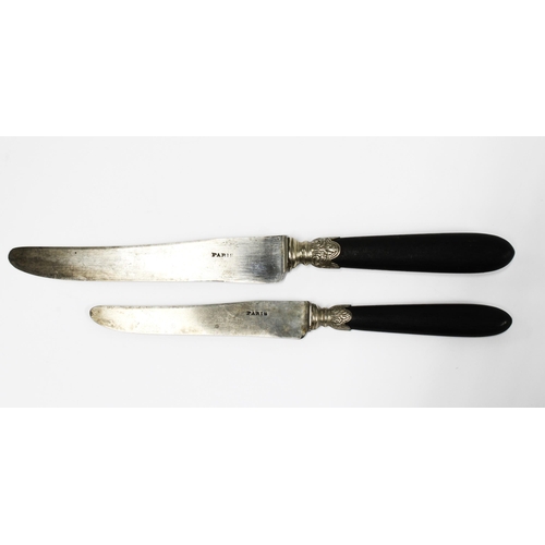 100C - French Empire knives, c1850 with ebonised handles and white metal mounts and steel blades, inscribed... 