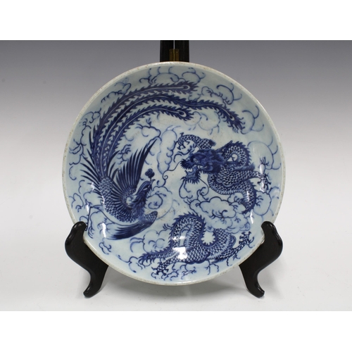 106 - Chinese blue and white dragon and phoenix bowl, 28cm.