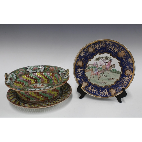 107 - Chinese famille rose pierced basket and stand and a plate with blue and gilt border (2) 30cm.